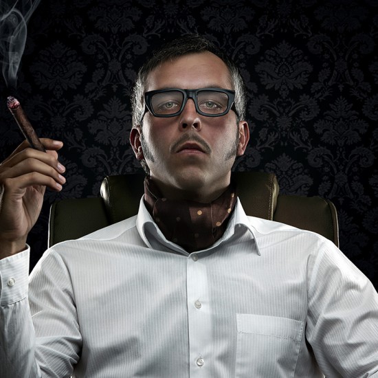 Funny portrait of rich man with serious face expression smoking